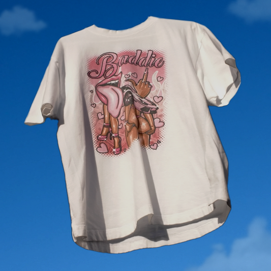 White t-shirt with graphic design against a blue sky