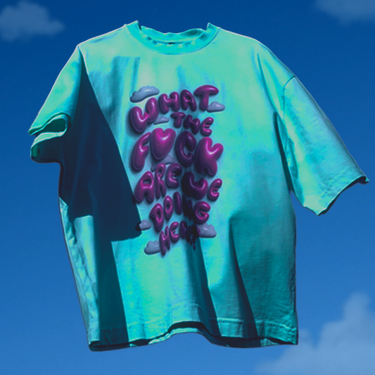 Teal t-shirt with purple text against a blue sky background